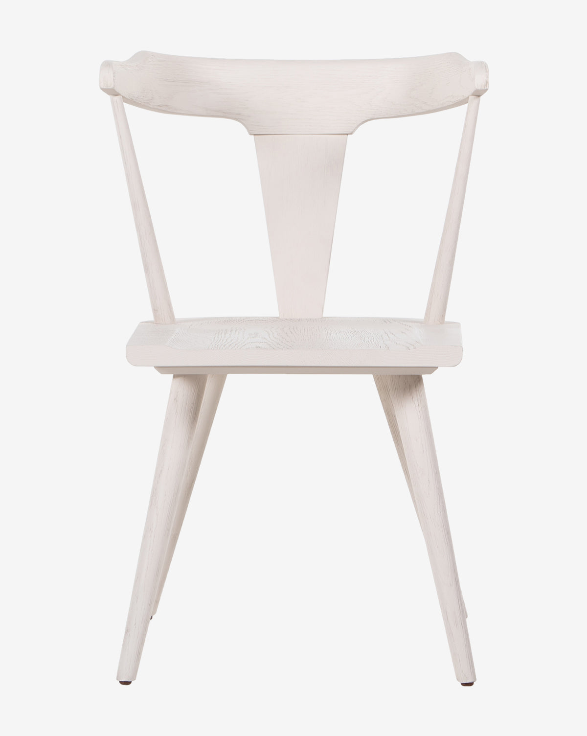 The Ruthie Dining Chair is a minimalist solid oak piece with a triangular backrest, angled legs, and a light natural finish, shown against a plain white background.