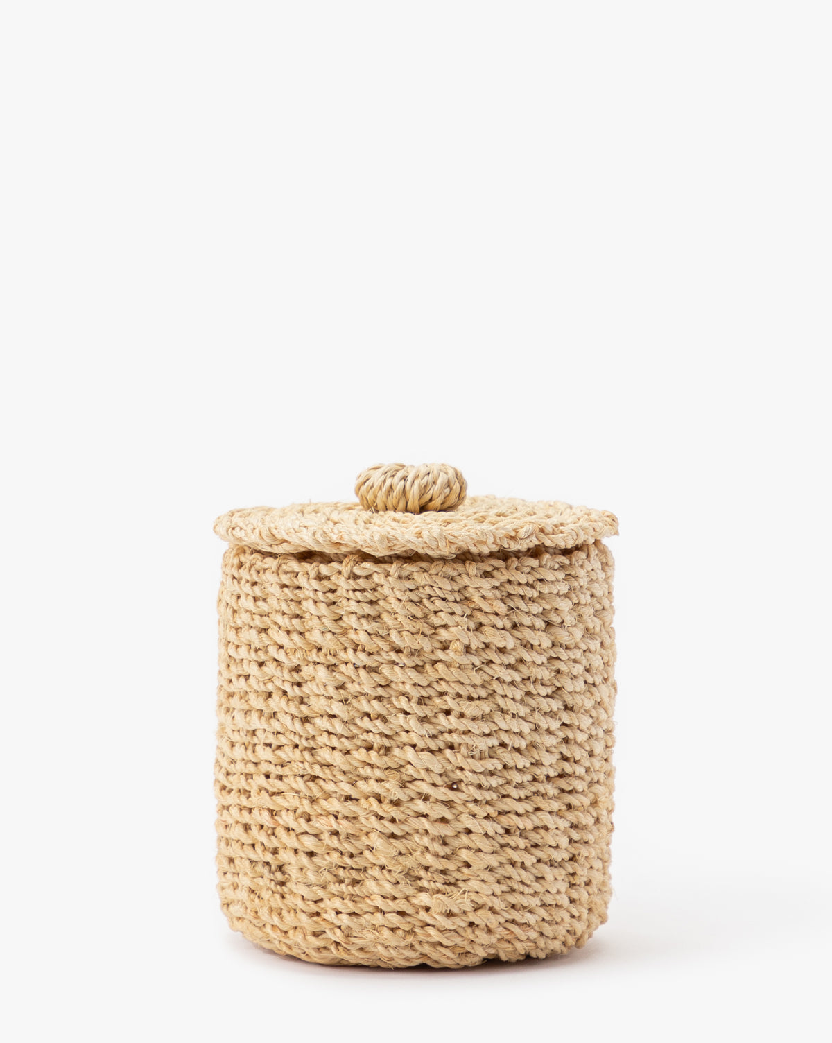 The Thalia Woven Canister, crafted from natural abaca fibers with a matching lid and knob, sits on a white background—ideal for organic storage or stylish bathroom decor.