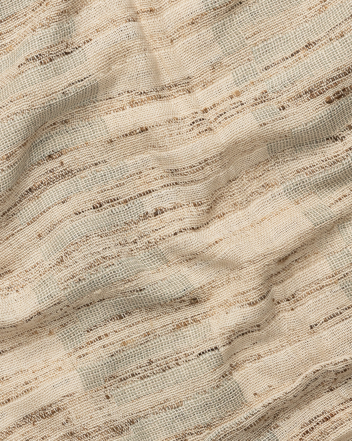 A close-up of the Theodora Block Stripe Throw shows beige and brown woven fabric, with visible texture and irregular horizontal lines for a natural, slightly rustic look.