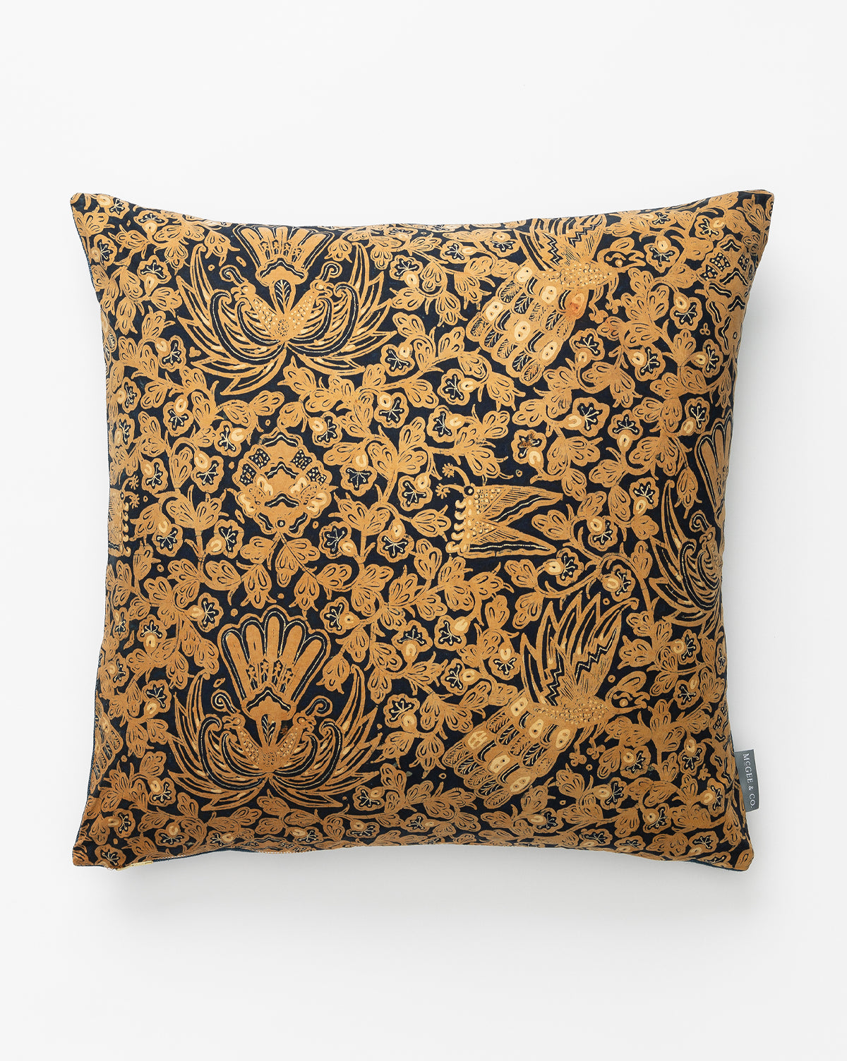 The Vintage Gold Patterned Pillow Cover No. 4 features a black background with intricate golden floral and bird batik designs and a small gray tag on one side for an elegant, heirloom-quality look, by McGee & Co.