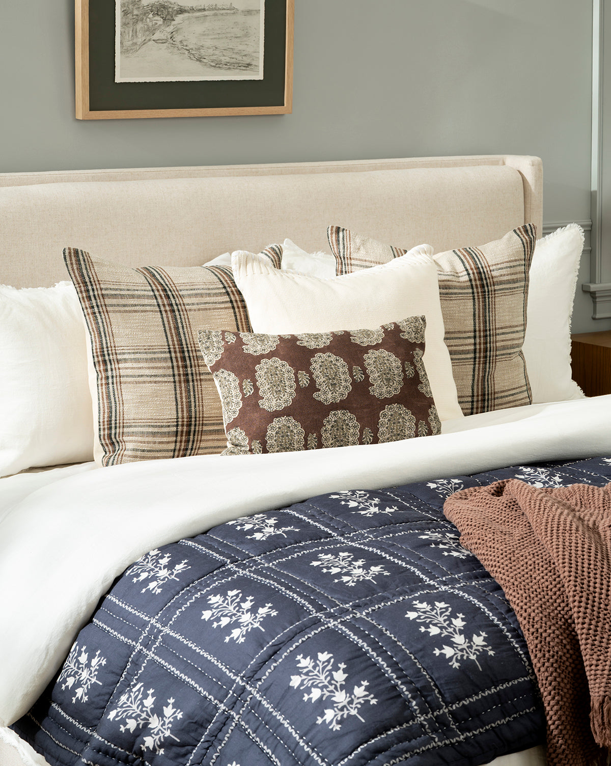 The Atherton Quilt in navy blue, featuring white florals, adds heirloom-inspired charm to the ensemble, by McGee & Co.