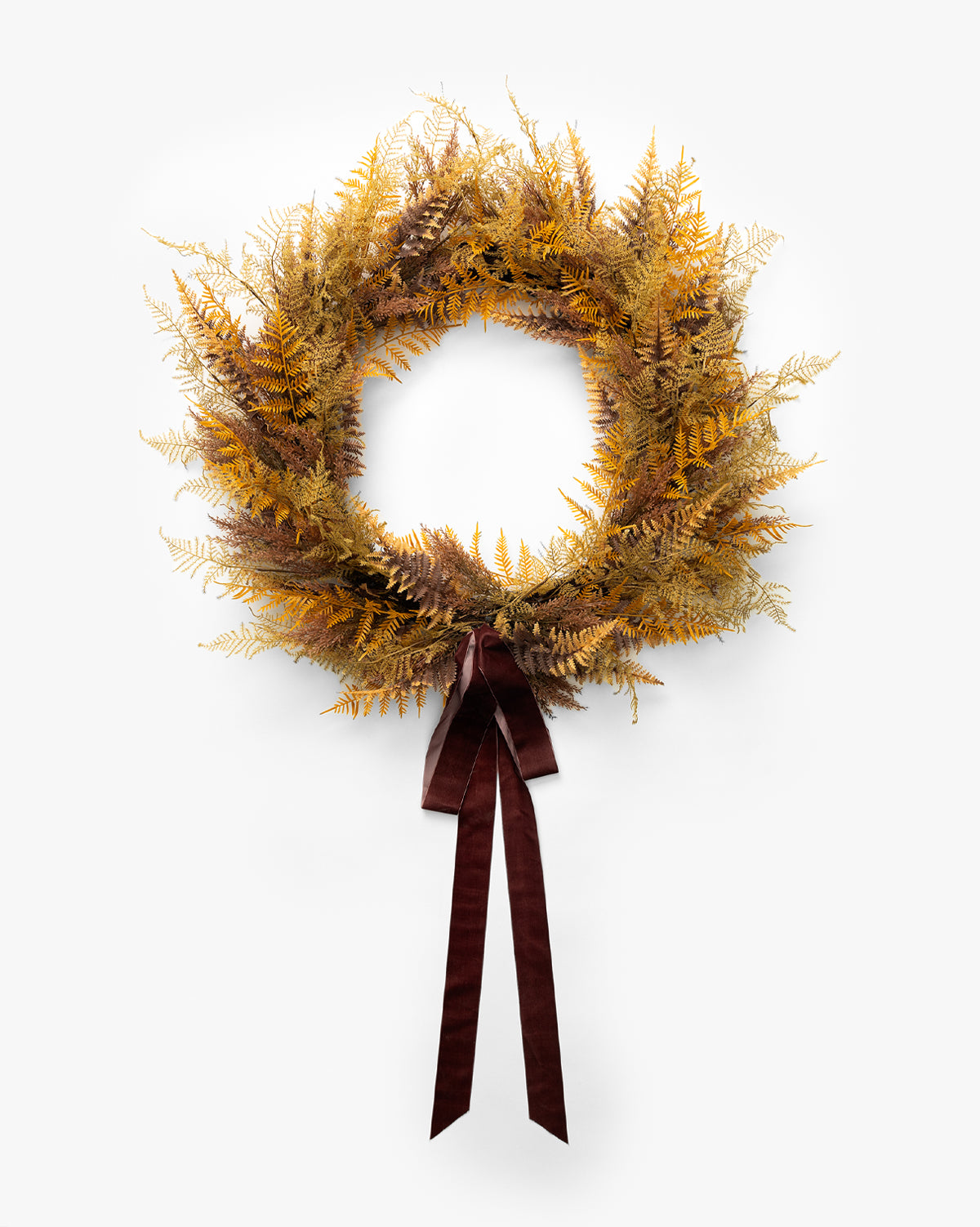 The 30 Faux Golden Fern Wreath, featuring yellow and brown dried-look ferns and a dark brown ribbon bow, is ideal for fall décor or as an entryway accent against a plain white background, by McGee & Co.