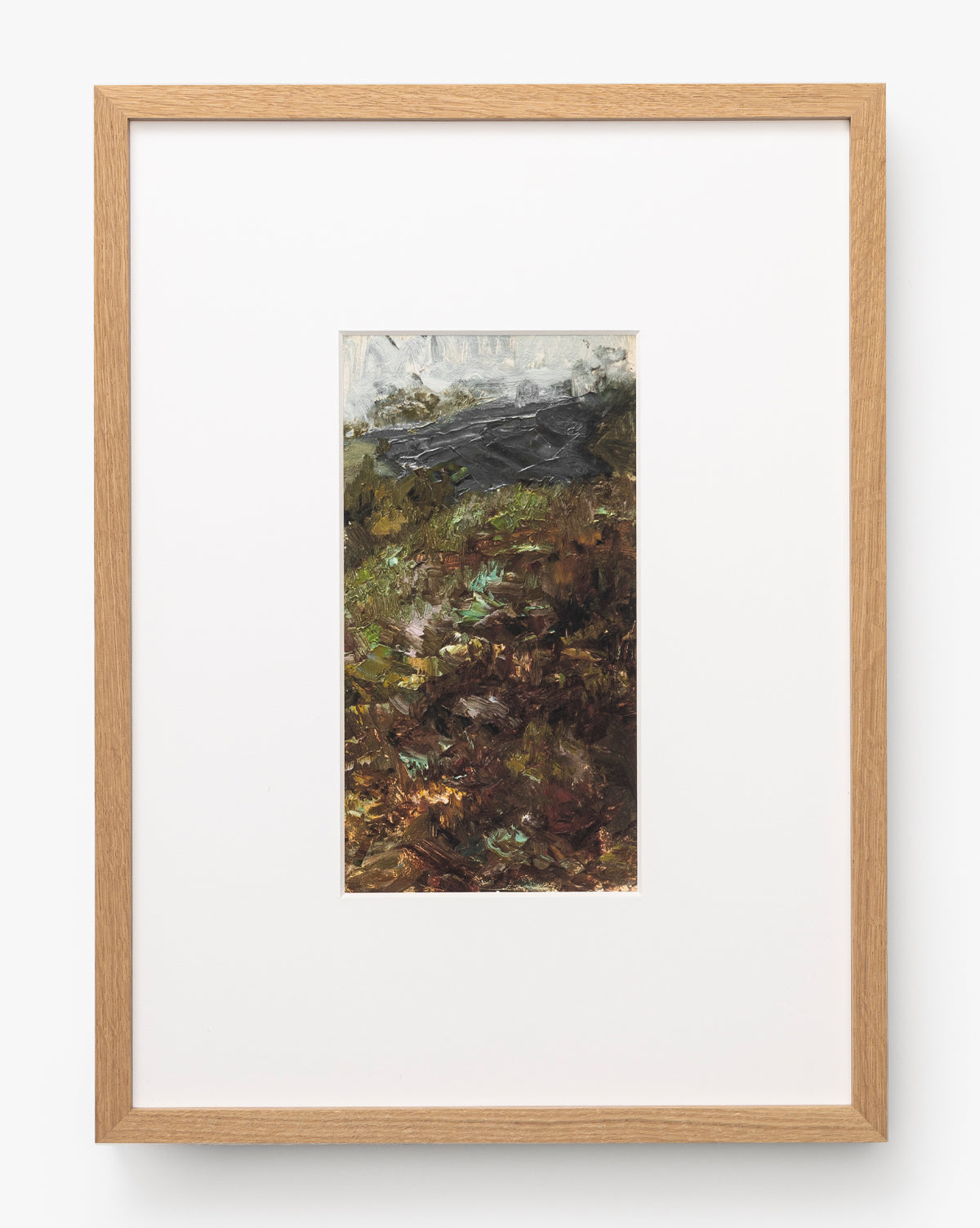 A River Runs Through is a framed abstract painting with earthy browns, greens, and dark grays, featuring textured brushstrokes. Centered within a large white mat and light wood frame, it evokes abstract landscapes by McGee & Co.
