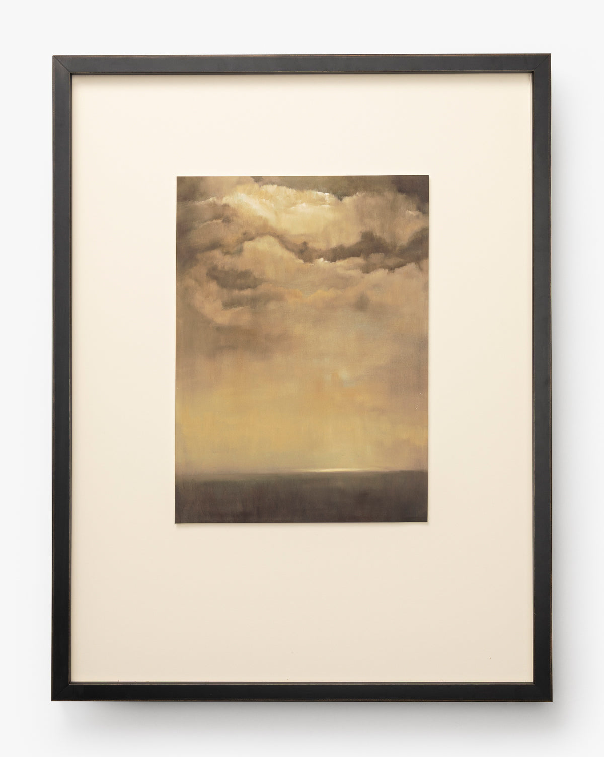Bright Horizons by Donna Thomas, a framed giclée print featuring a cloudy sky with warm golden and brown tones at sunset or sunrise, hangs centered on a light background. The soft horizon near the bottom enhances this elegant wall art, by McGee & Co.