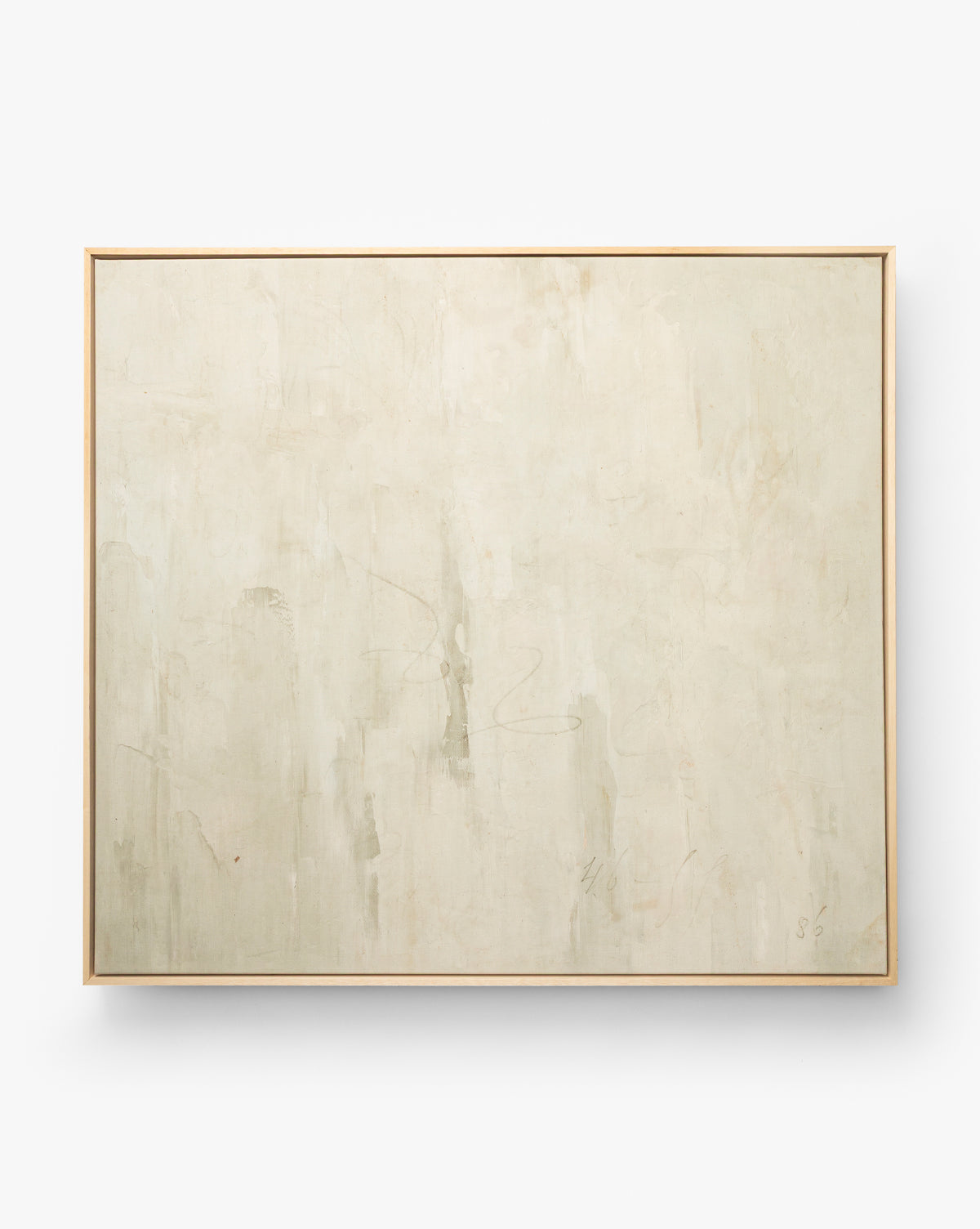 Brushes in Neutral is a minimalist abstract wall art featuring a pale off-white background, subtle beige and gray brushstrokes, and gentle texture—elegantly presented as a framed giclée in a light wood frame, by McGee & Co.