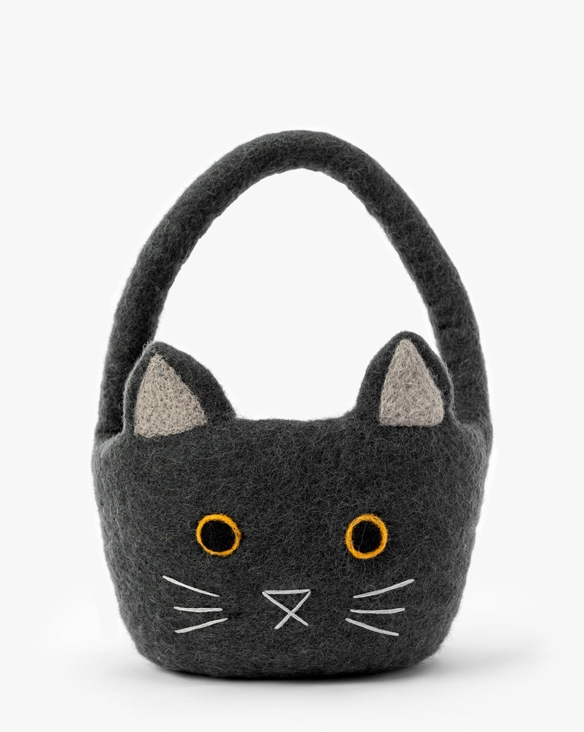 The Cat Trick or Treat Felt Basket is a gray felt basket shaped like a cat’s face with pointy ears, orange eyes, white stitched whiskers, and a top handle—ideal for Halloween decor or collecting treats, by McGee & Co.