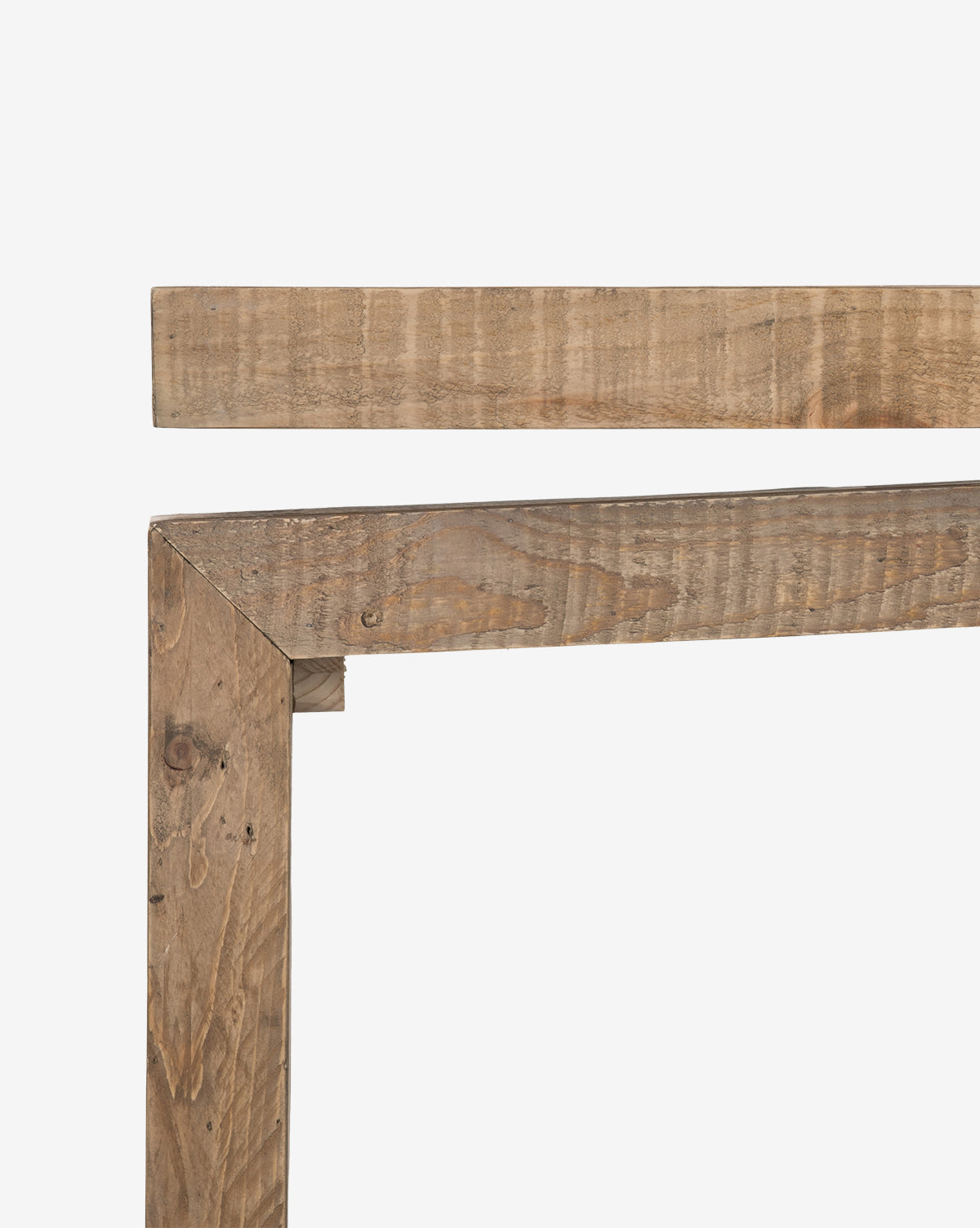 A close-up shows two unfinished reclaimed wood planks joined at right angles, forming a partial corner structure—an element featured in modern entryway table designs such as the Colter Console Table—set against a white background, by McGee & Co.