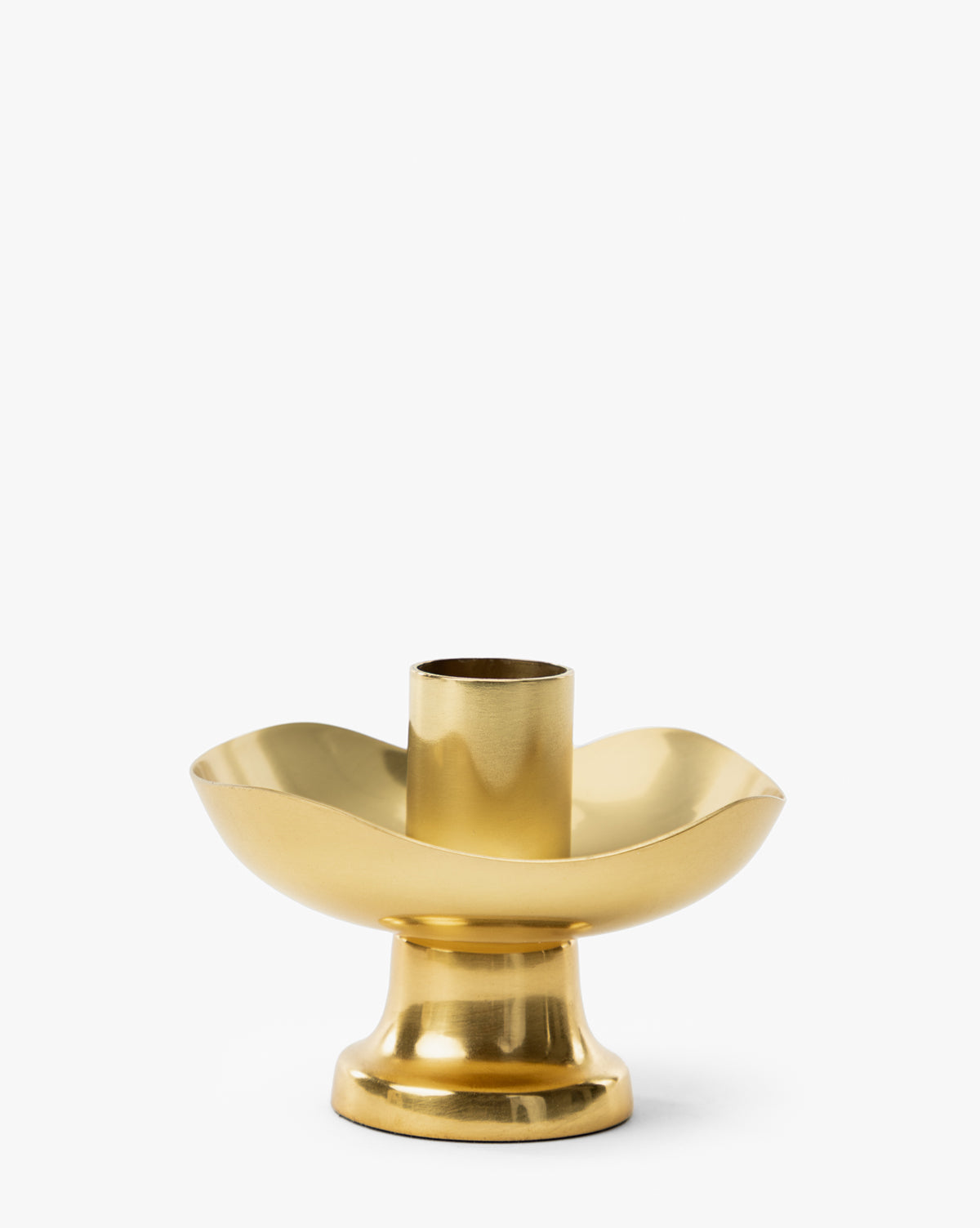 The Cosima Taper Holder features an antique brass finish, a wide curved base, and a central cylindrical holder—bringing elegant decor to any space, as shown against a plain white background, by McGee & Co.