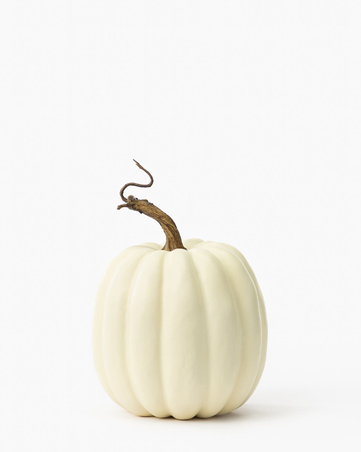 The Creamy White Faux Pumpkin features a curved brown stem and sits on a plain white background, making it an ideal neutral accent for your fall décor, by McGee & Co.