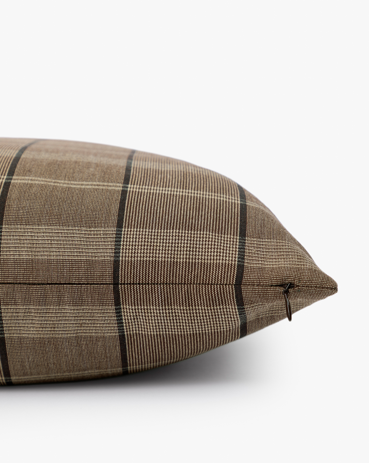 A close-up side view of the Curtis Pillow Cover in brown plaid with a subtle checkered pattern, displayed on a white surface against a plain background—a stylish decorative accent for any space, by McGee & Co.