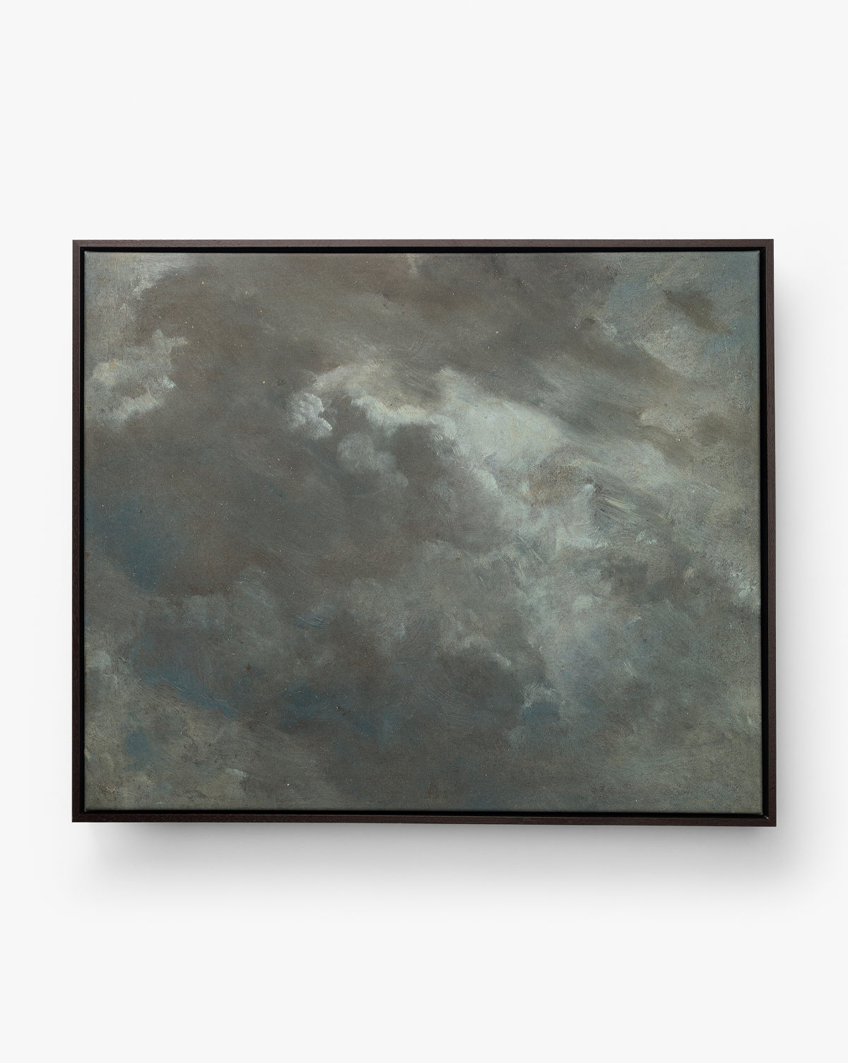 Dark Skies Ahead is an abstract giclée canvas featuring a moody, atmospheric sky in gray and blue hues, elegantly showcased in a sleek floater frame, by McGee & Co.