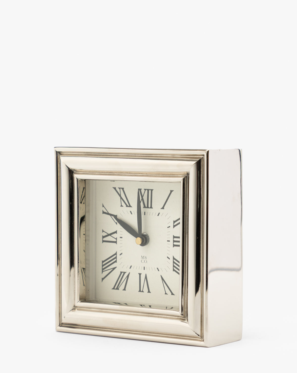 A Draper Clock in polished nickel with Roman numerals and black hands is shown against a plain white background, displaying the time as 11:01, by McGee & Co.