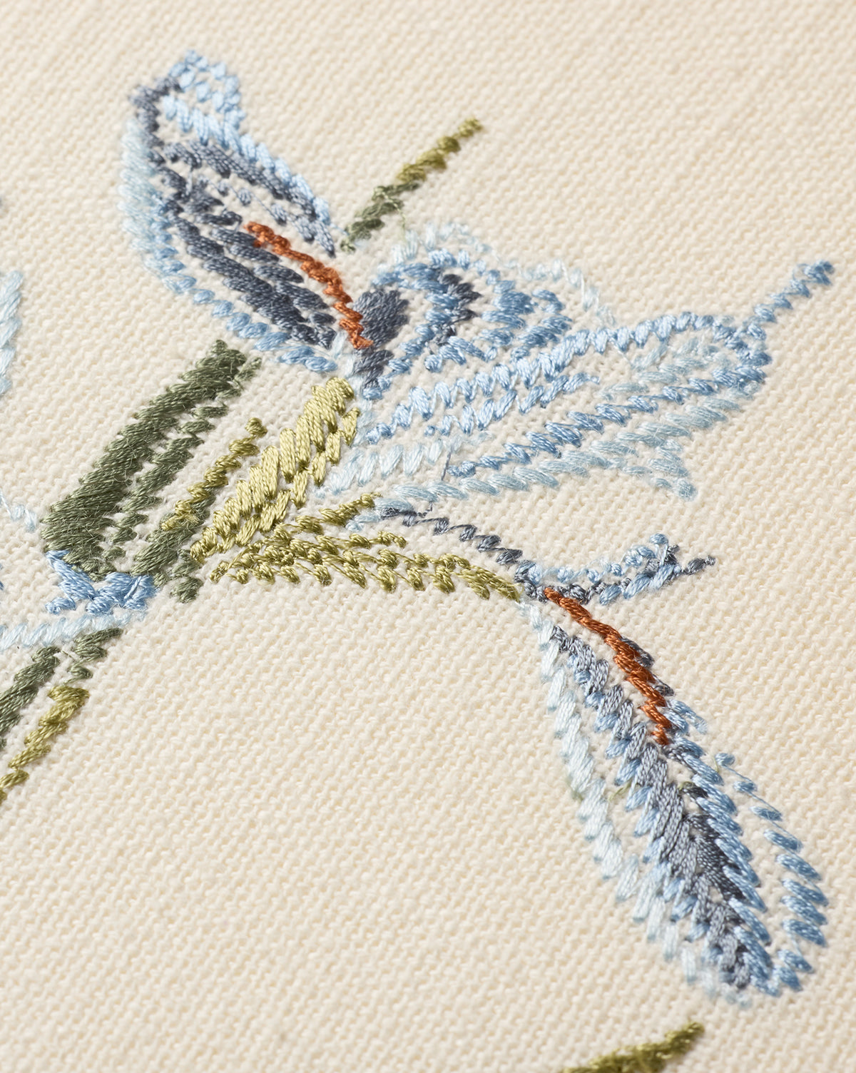 Close-up of the Embroidered Blue Iris, showcasing cotton embroidery in green and brown on beige fabric—perfect as botanical wall art, by McGee & Co.