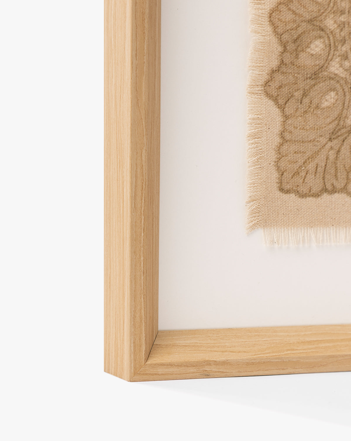 Close-up of the European Flare frame highlights its natural woodgrain and vintage-style wall art—a beige fabric with a decorative floral pattern—bringing elegant European charm to any space, by McGee & Co.