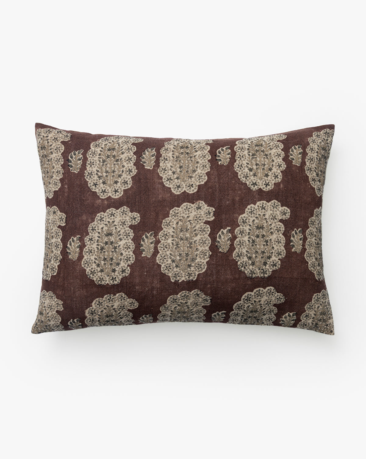 The Ginny Block Print Linen Pillow Cover features a brown background with a hand-block-printed, symmetrical beige floral and leaf design in a repeating pattern, by McGee & Co.