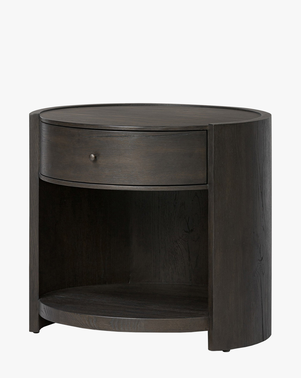 The Glenndon Oak Nightstand is a round bedside table with a black finish, featuring modern lines, a single drawer with a round knob, and an open shelf below, by McGee & Co.