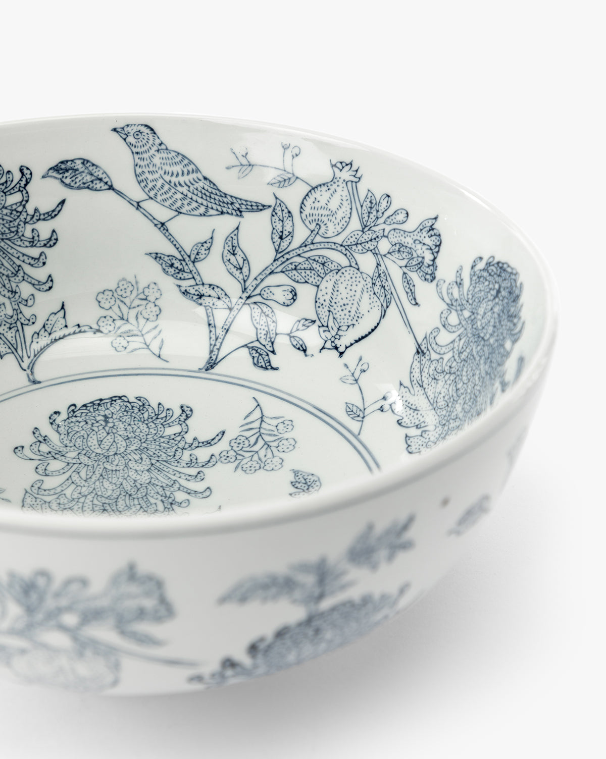 The Hand Stamped Botanical Bowl is a white stoneware bowl with detailed blue bird and floral designs on the inner surface, shown against a plain white background, by McGee & Co.