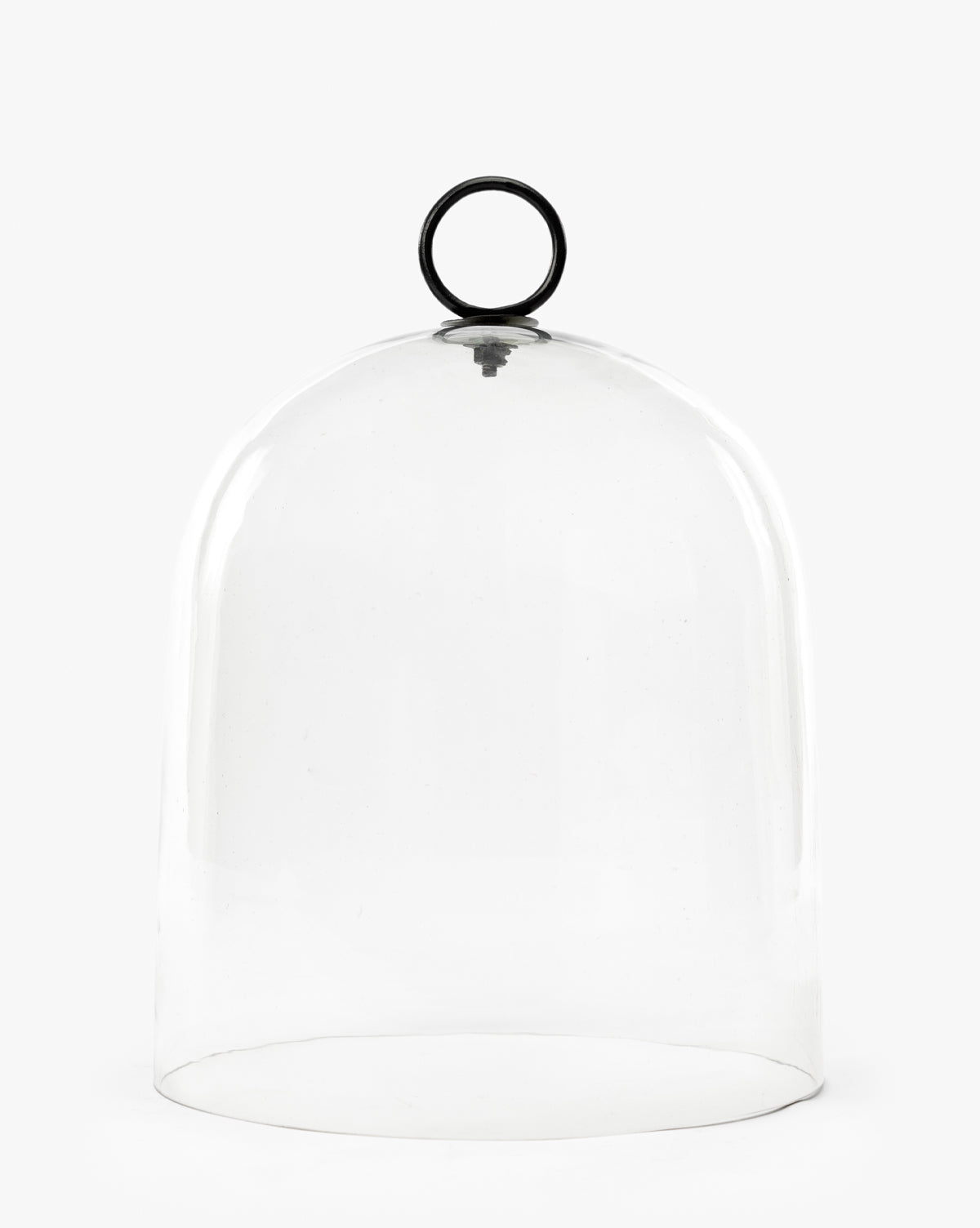 The Hazy Cloche features a clear, rounded glass dome with a black circular handle on top, displayed against a plain white background by McGee & Co.