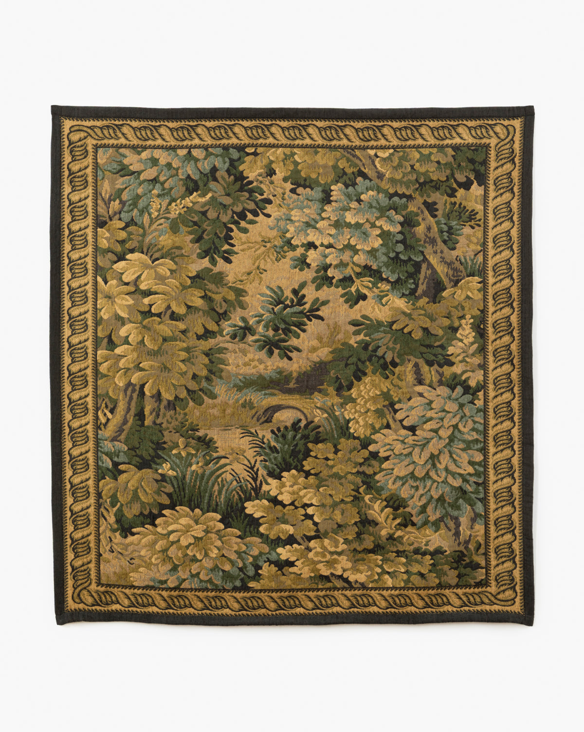 The Hortensia Wall Tapestry showcases a lush forest scene with dense green and gold foliage, trees, and a small stream, all framed by an intricate woven border, by McGee & Co.