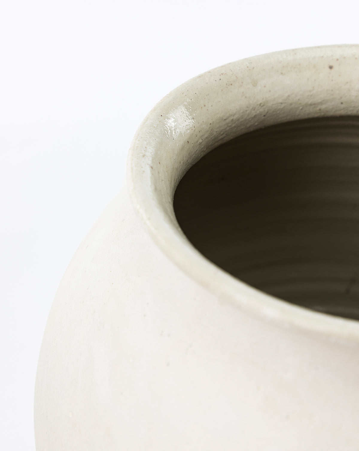 Close-up of the Isla Terracotta Vase’s rim and upper side features its smooth, slightly glossy finish and subtle organic texture against a plain white background—an ideal accent to elevate your home decor, by McGee & Co.