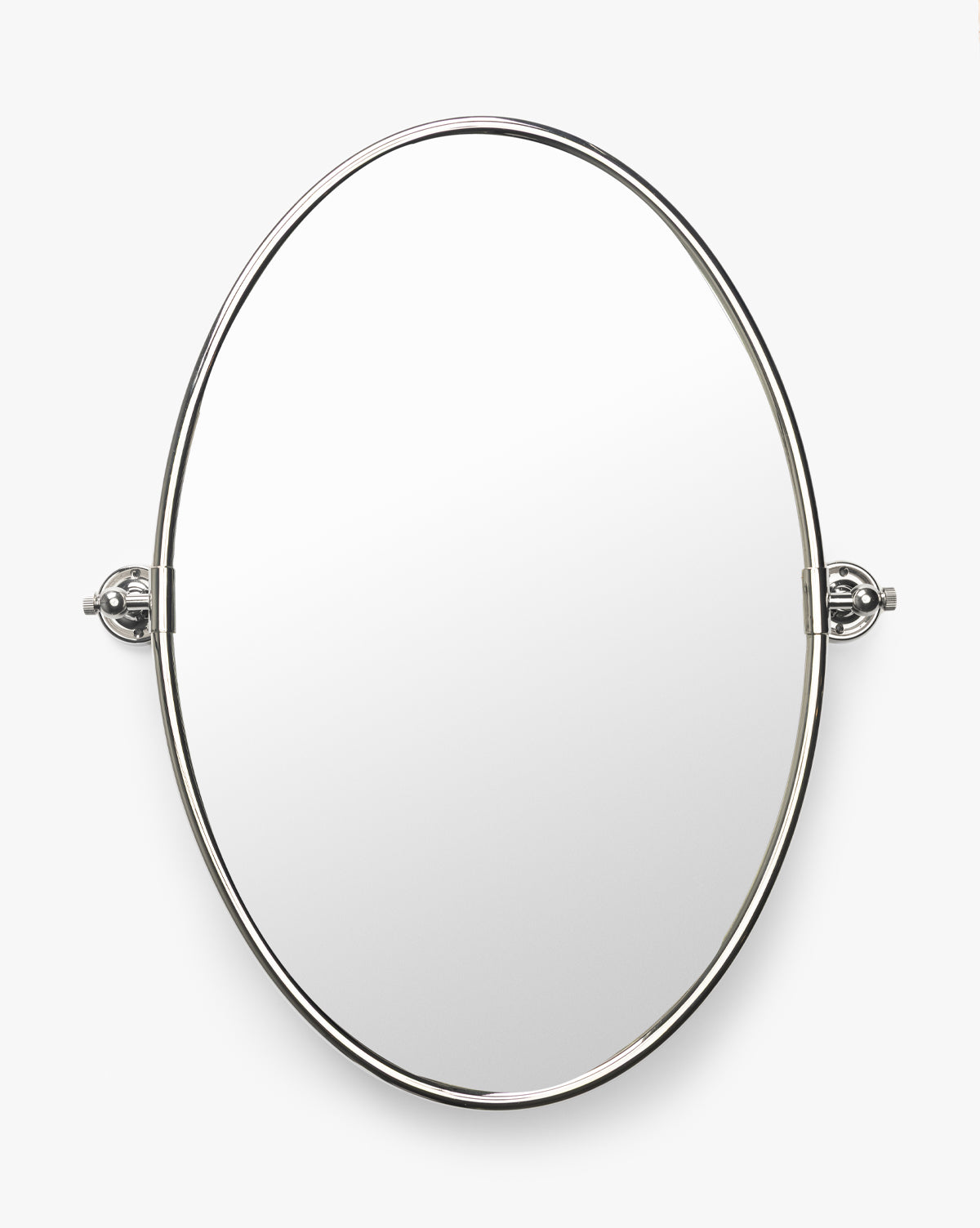 The Kitson Oval Mirror features a slim, polished antique brass frame and two adjustable side brackets. Wall-mounted, it stands out elegantly against a white background by McGee & Co.