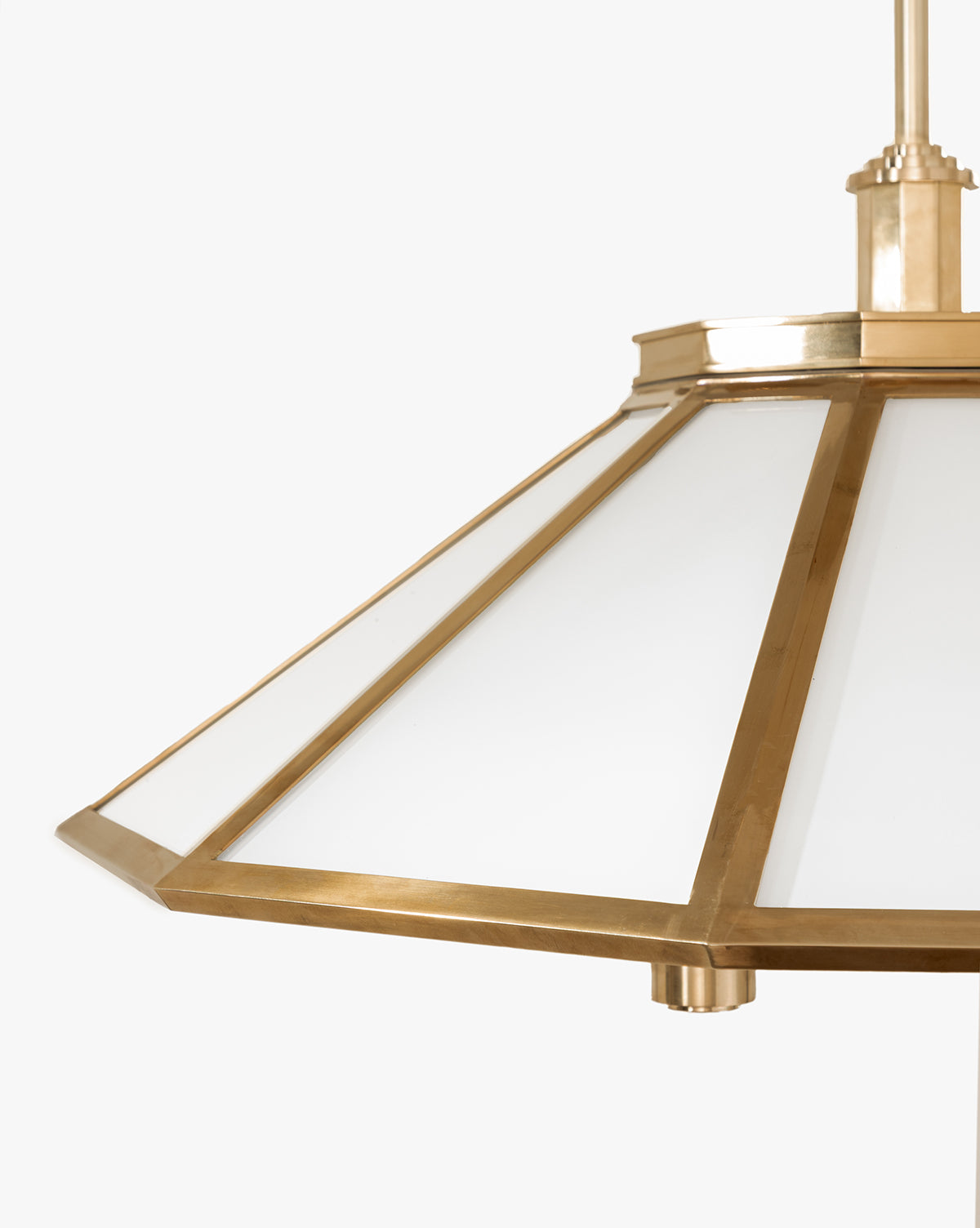 A close-up of the Knightley Chandelier, featuring an antique brass frame and frosted glass panels in a modern geometric design, set against a plain white background, by McGee & Co.