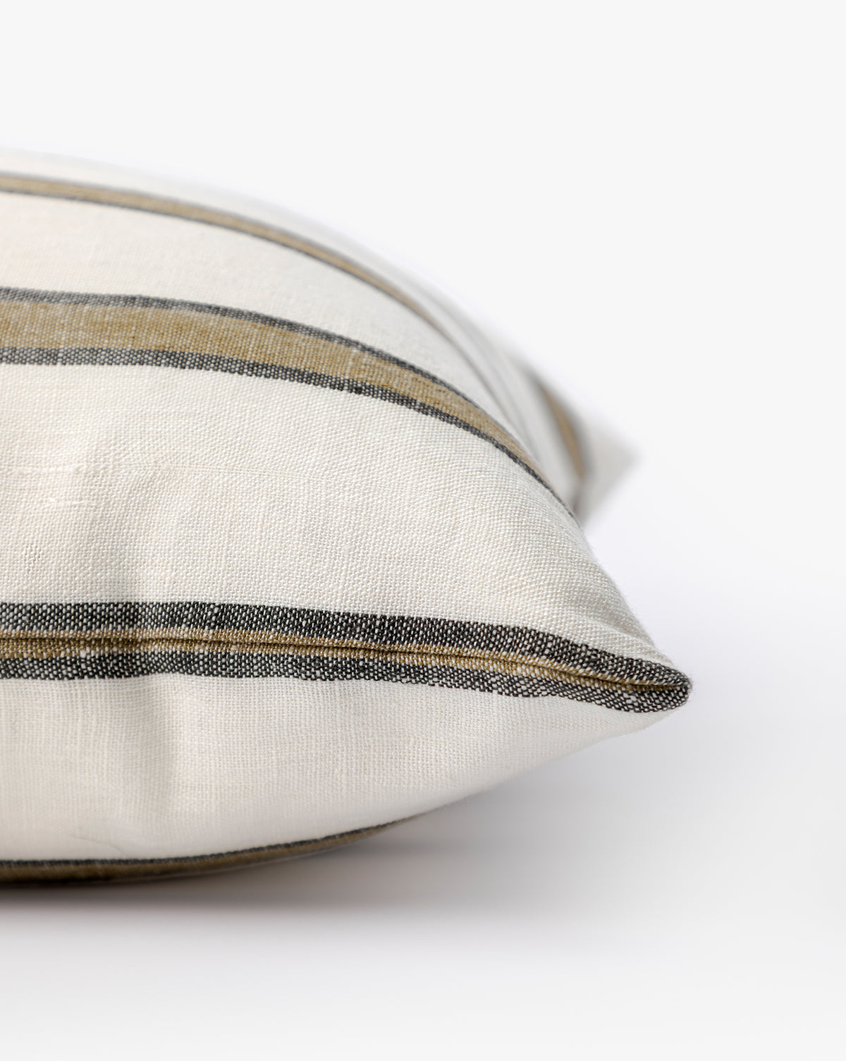 Close-up of the Lago Pillow Cover, featuring cream color with horizontal black and tan stripes. Set against a white background, its soft texture makes it ideal for adding a touch of cozy style to your space, by McGee & Co.
