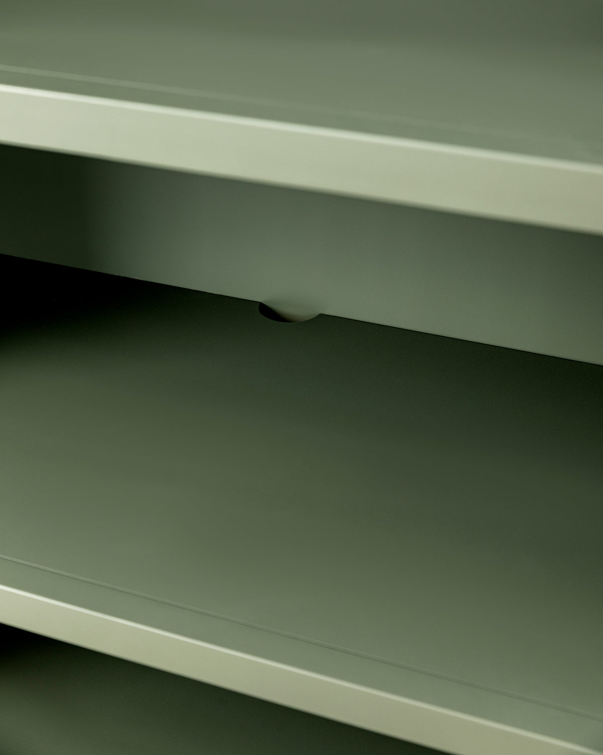 A close-up of the Liberty Bookcase’s empty, greenish-gray metal shelves highlights heirloom craftsmanship with a small notch visible on the edge of the middle shelf, by McGee & Co.