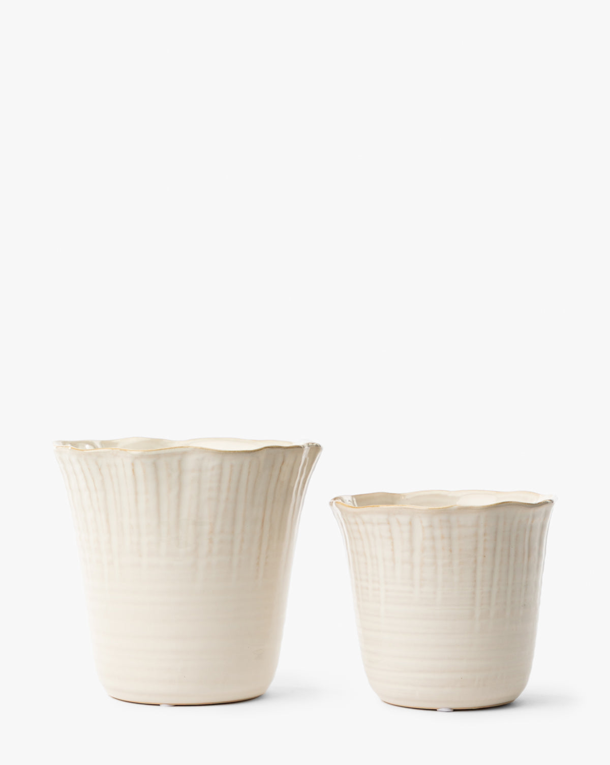 The London Planters (Set of 2) by Napa Home & Garden features cream-colored ceramic pots with scalloped edges and vertical textured lines, in two sizes, shown on a plain white background. McGee & Co.
