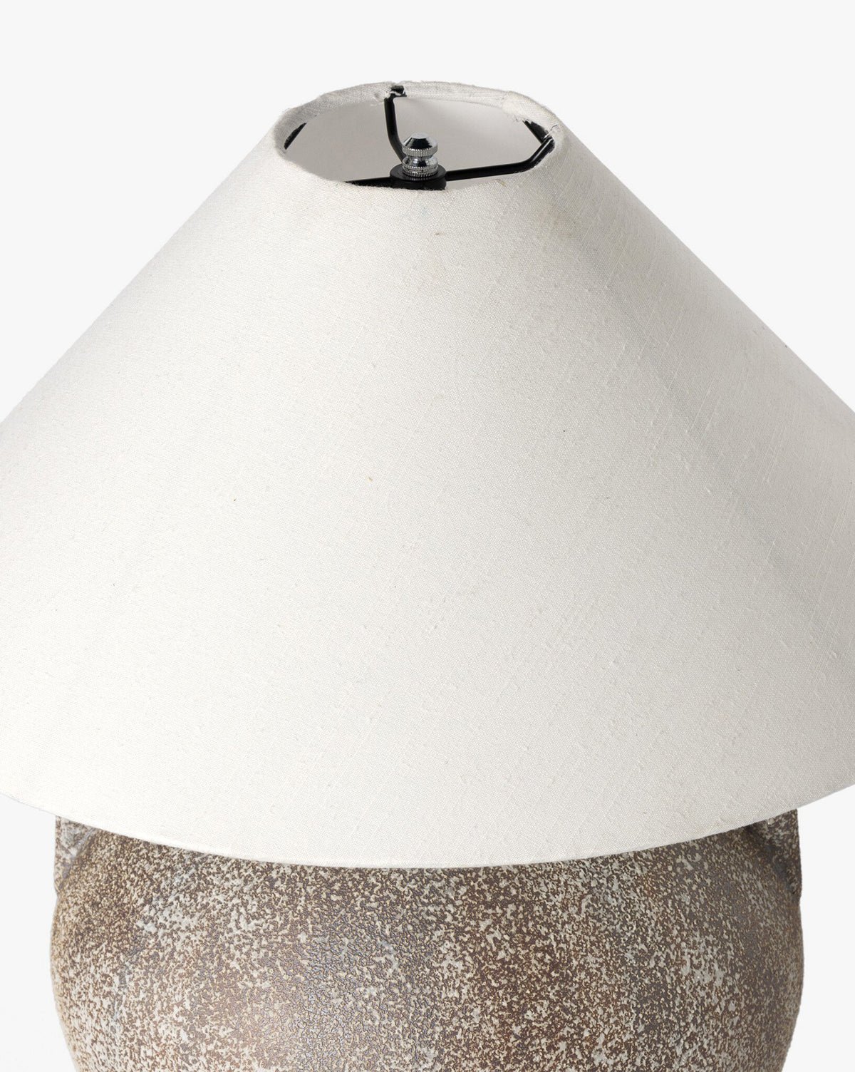 The Mays Table Lamp features a textured speckled brown base, inspired by vintage clay jars, paired with a wide off-white conical shade. Shown against a plain white background, by McGee & Co.