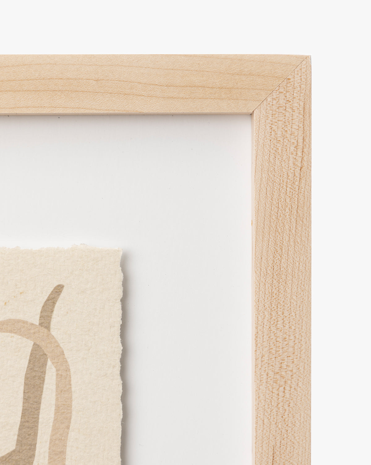 Close-up of the top right corner of a maple frame displaying Moth IV By Coup dEsprit on textured off-white paper with beige abstract details. The plain white background makes it ideal for nursery wall art or modern interiors, by McGee & Co.