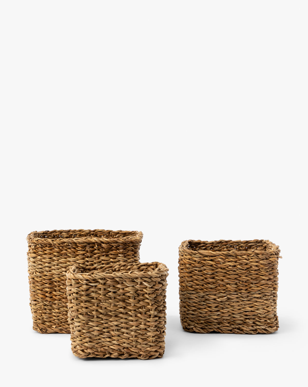 The Piers Baskets (Set of 3) features square woven baskets in varying sizes, crafted from natural fibers with braided patterns and open tops, displayed against a plain white background by McGee & Co.