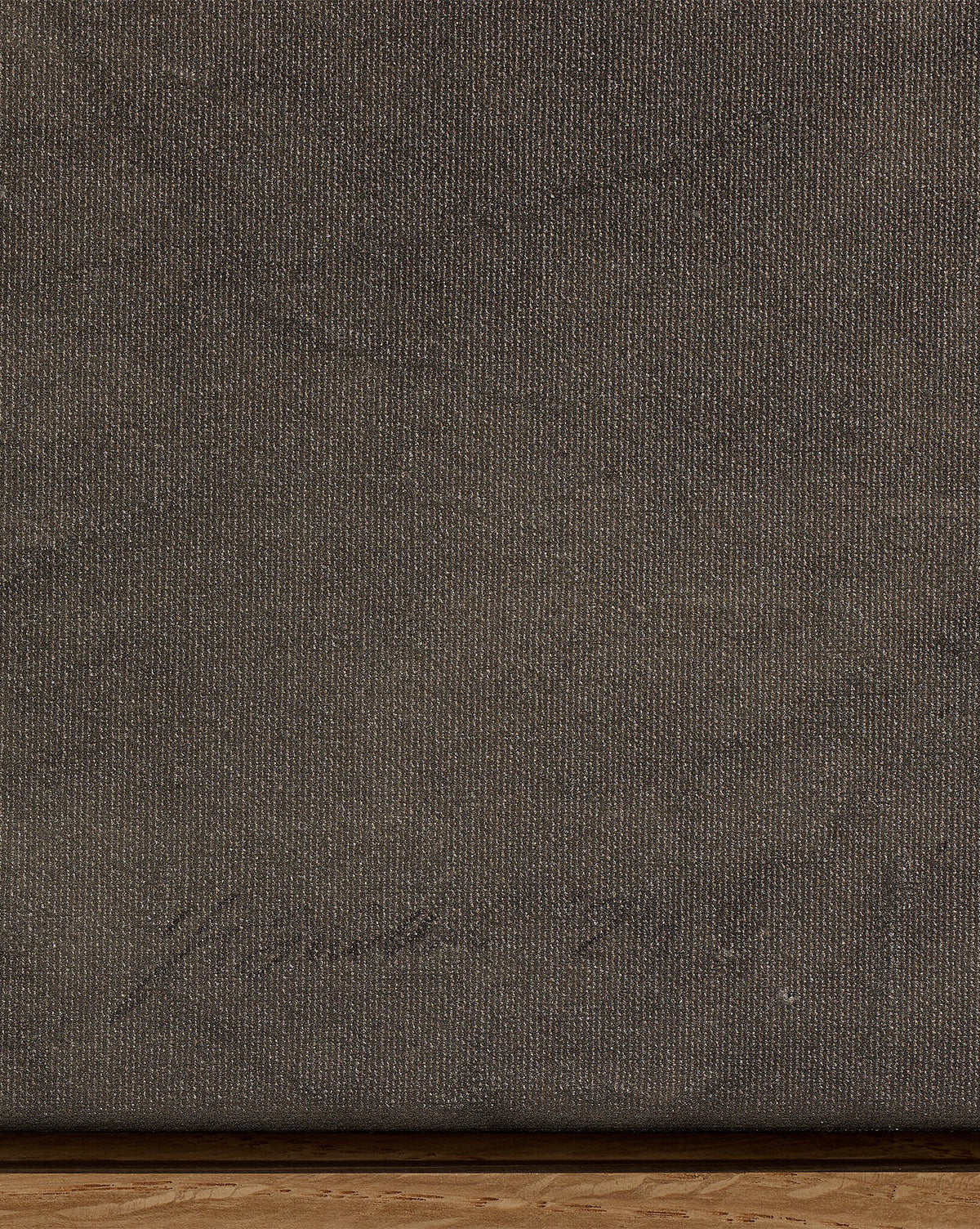Close-up of Pinecorn III by Kimmy Quillin: a textured dark brown canvas in earthy tones with faint handwriting in the lower left corner and a thin wooden edge visible at the bottom, by McGee & Co.