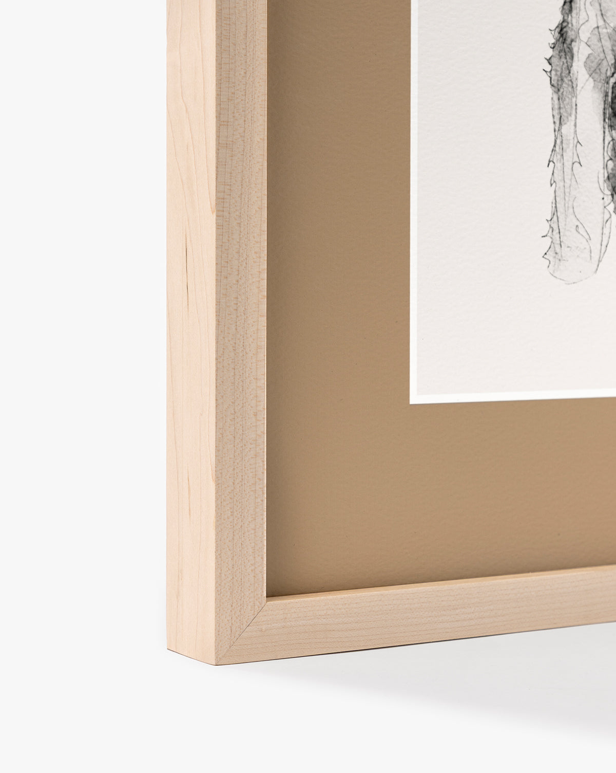 Close-up of the Rex maple frame with a beige mat, featuring part of a black-and-white schnauzer watercolor on white paper. Only one corner of this charming nursery wall art is shown, by McGee & Co.