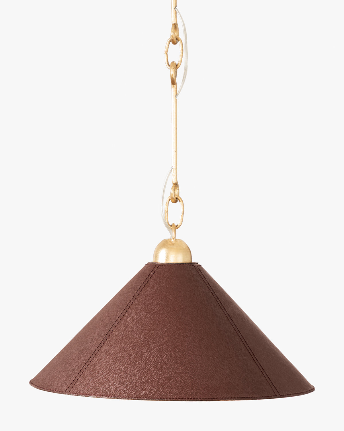 The Scarlett Pendant showcases a wide conical brown leather shade with gold leafed iron fixtures, hanging from a gold chain for an elegant look against a white backdrop, by McGee & Co.