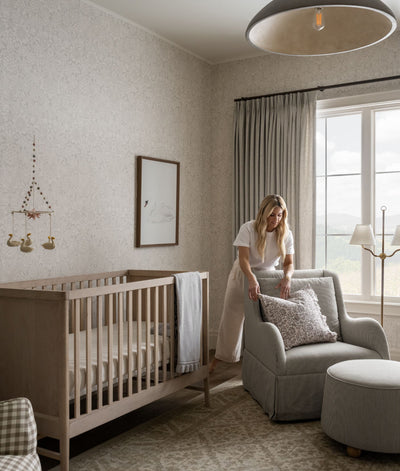 Shea, the owner of McGee & Co., carefully decorating a nursery.