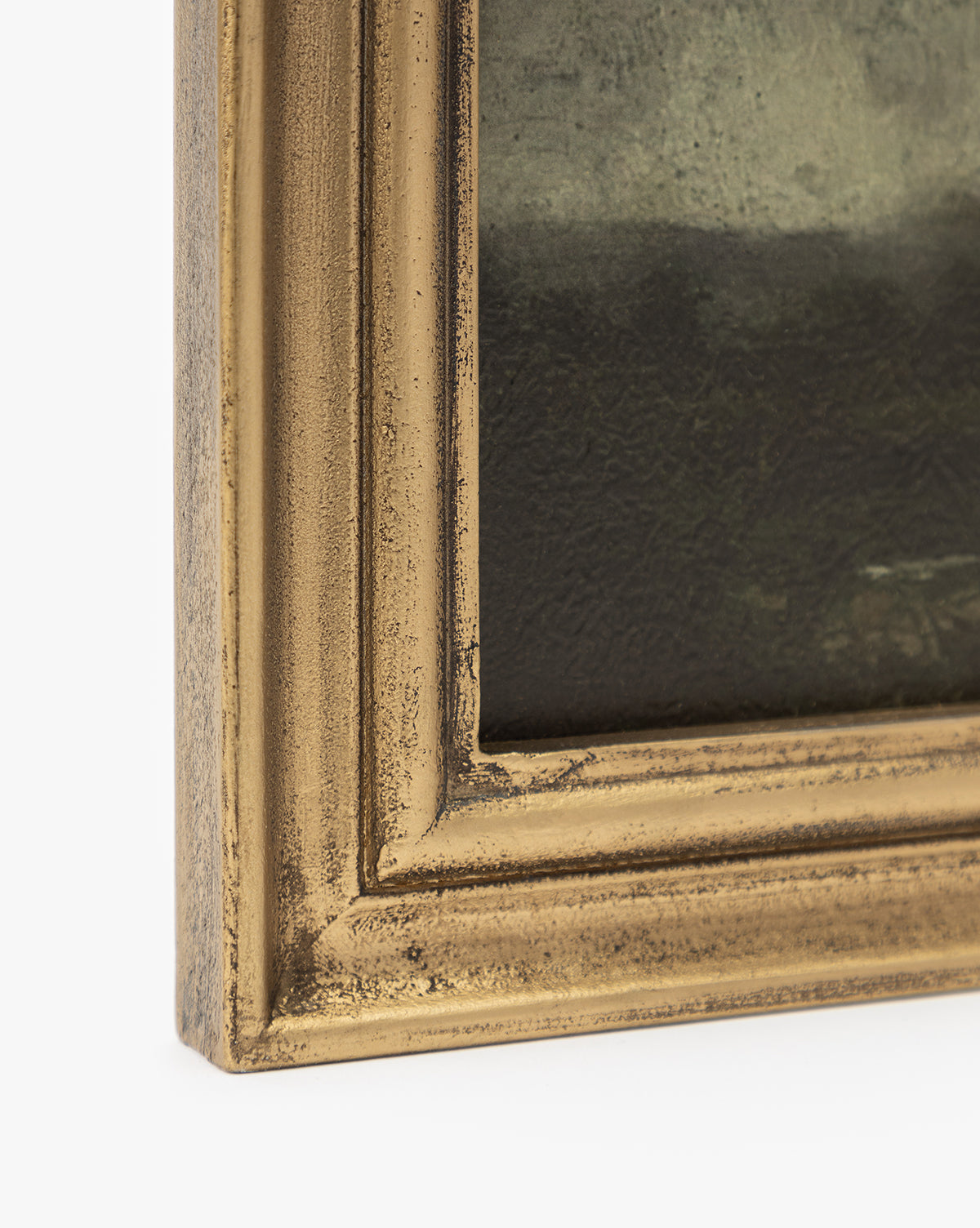 Close-up of the corner of a gold wood frame with a textured, slightly worn finish, showcasing part of Storm on the Lake, a dark-toned painting. This antique-look frame makes it a unique addition to any home decor.