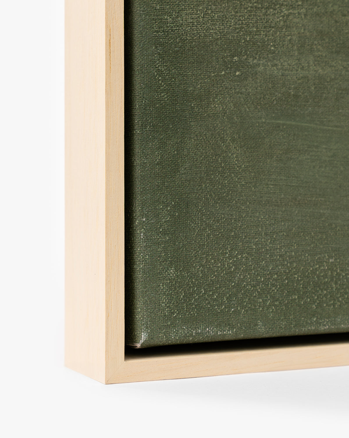Close-up of the Stormy Sky Afternoon wall art, showcasing a natural wood frame and a textured, dark green, gallery-wrapped canvas, by McGee & Co.