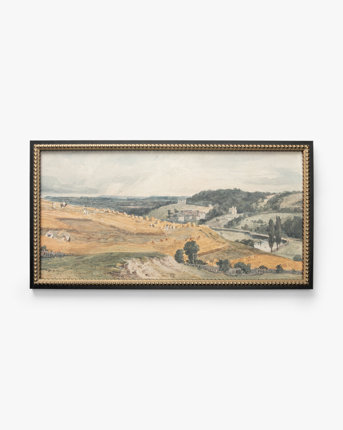 The framed artwork View of St Catherines Hill Near Guildford by Charles Claude Pyne shows rolling hills, golden fields, scattered trees, and distant buildings beneath a partly cloudy sky, by McGee & Co.