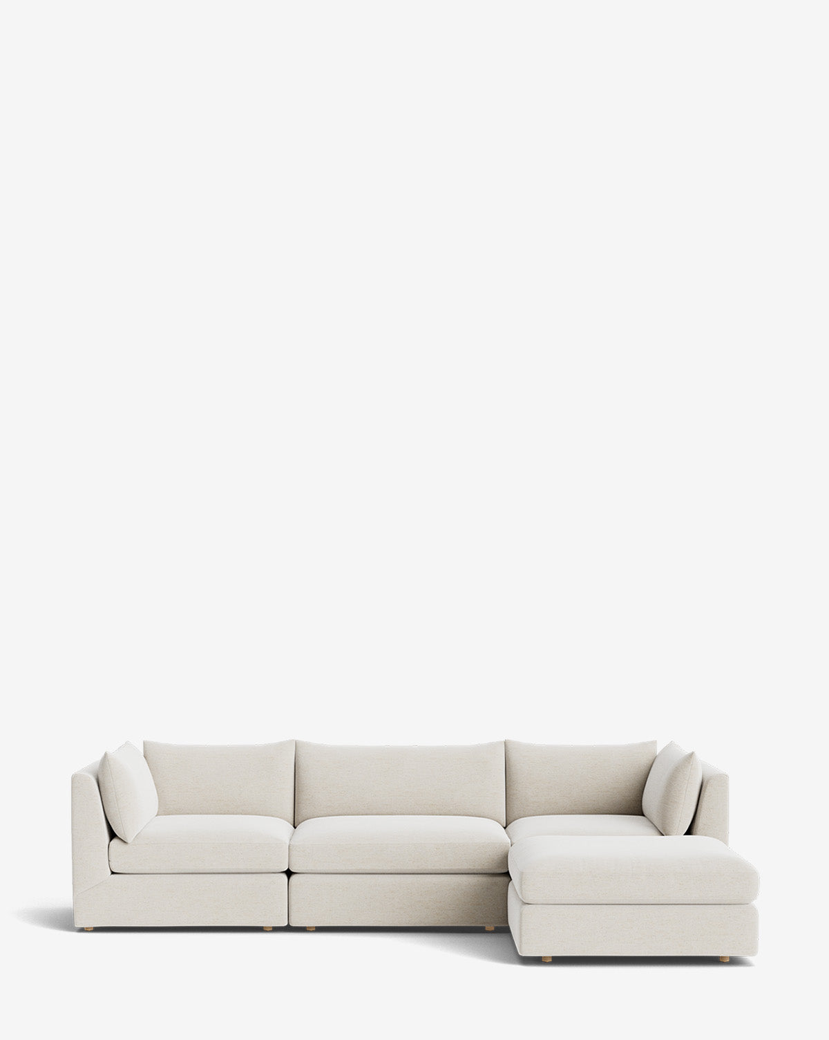 The Vivienne Modular Sofa with Ottoman features a modern, light beige design with three seat cushions on the left, a chaise lounge on the right, and two matching throw pillows at each end, set against a plain white background by McGee & Co.