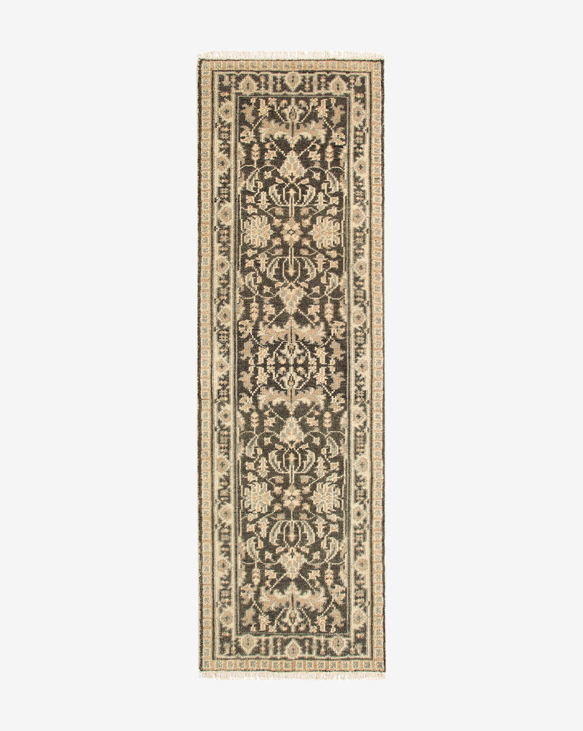 The Wayland Hand-Knotted Wool Rug is a rectangular narrow runner featuring an intricate black and beige floral and vine pattern, decorative border, and fringed ends—an artisan wool rug of exquisite craftsmanship, by McGee & Co.