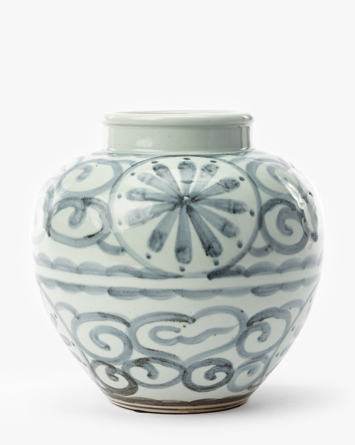 The Wilfred Vase is a round ceramic jar with a short, wide neck, featuring blue floral and swirling cloud designs on a glossy white background. It sits on a flat surface against a plain white backdrop, by McGee & Co.